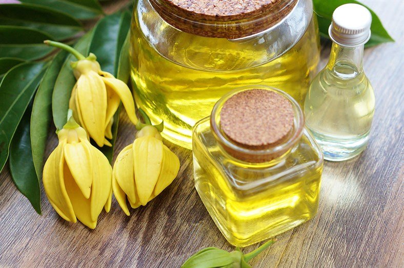 ylang ylang essential oil with flowers