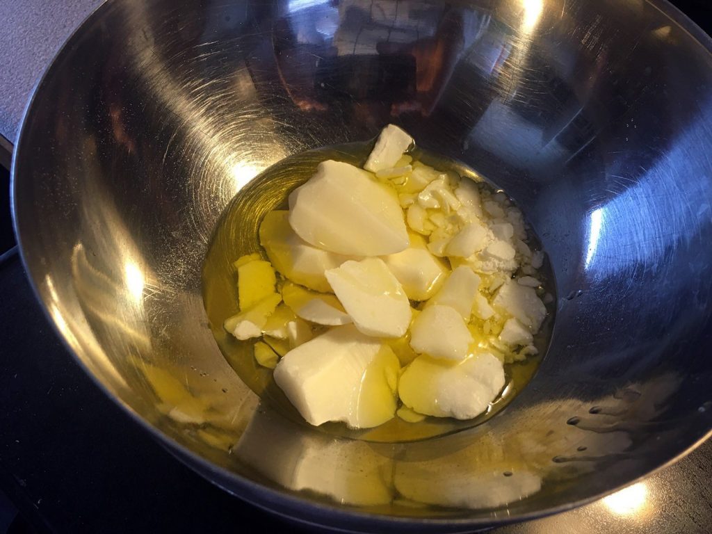 double boiler with cocoa butter and jojoba oil