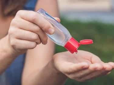 woman using homemade hand sanitizer