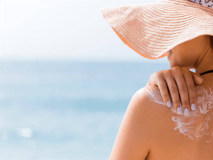 woman applying homemade after sun lotion