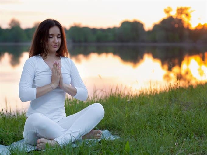 woman meditating outdoors