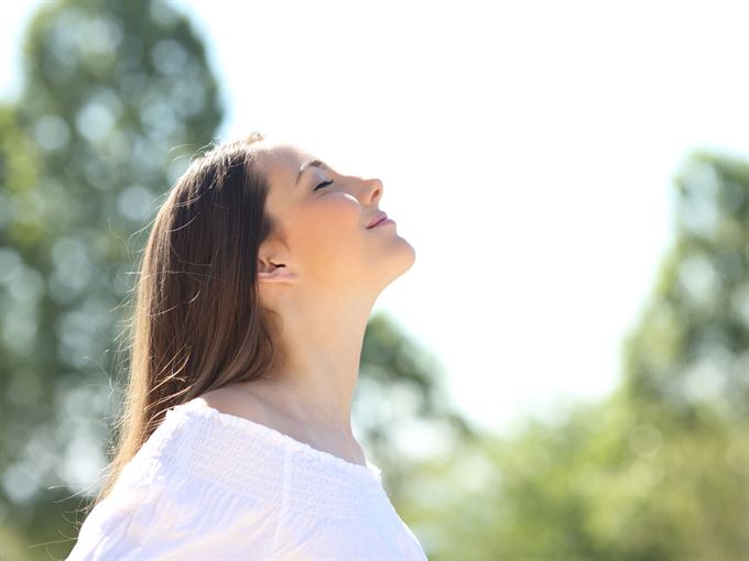 woman taking fresh breath of air