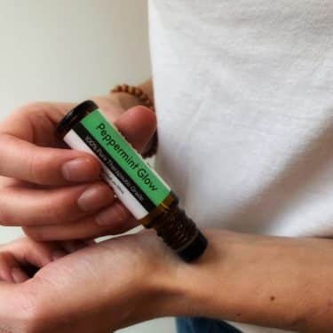 applying essential oils for headache relief on wrist